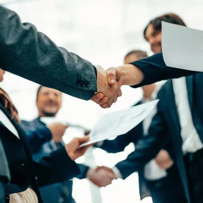 Group of people shaking hands.