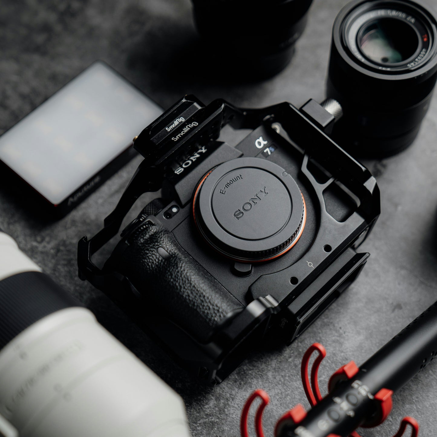 Sony camera with lenses and accessories on a gray surface