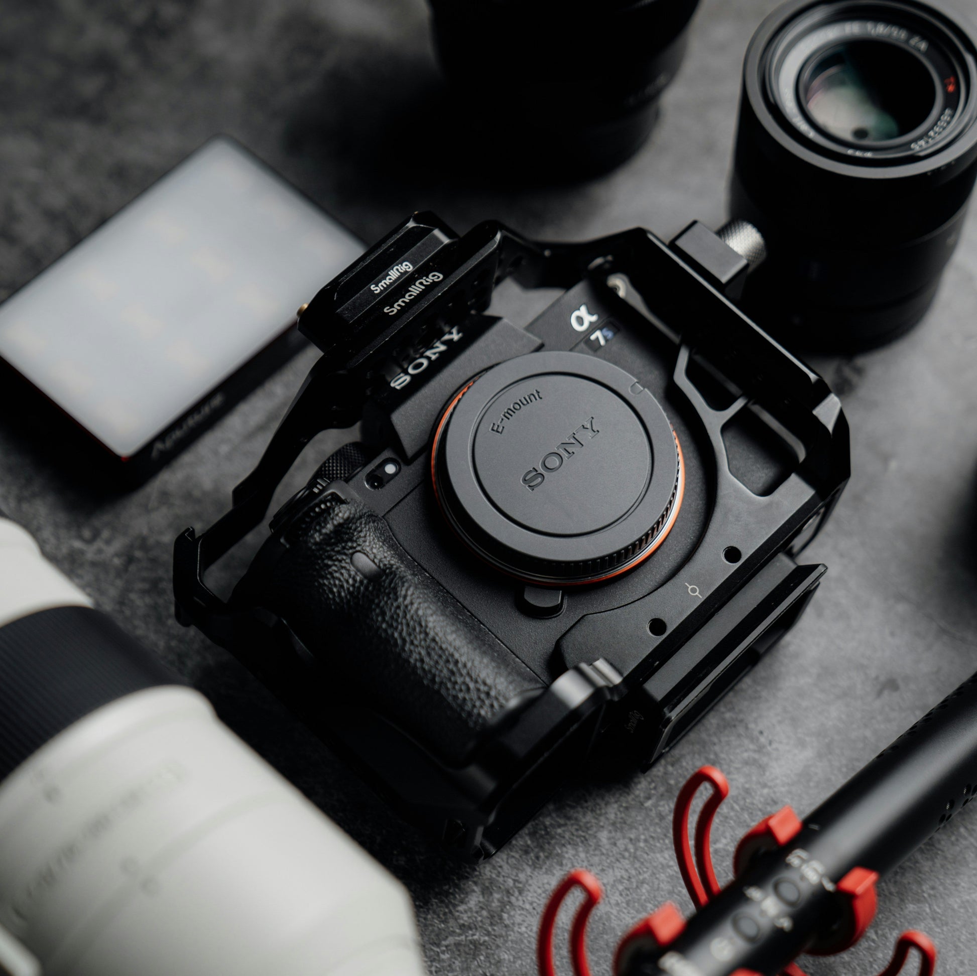 Sony camera with lenses and accessories on a gray surface
